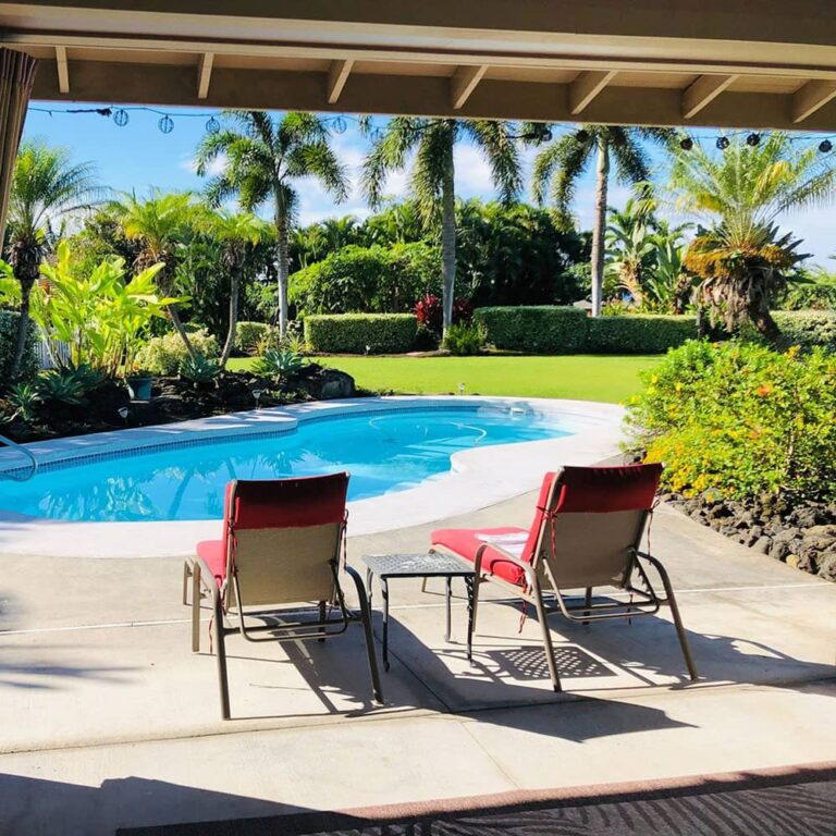 2 chairs facing a pool